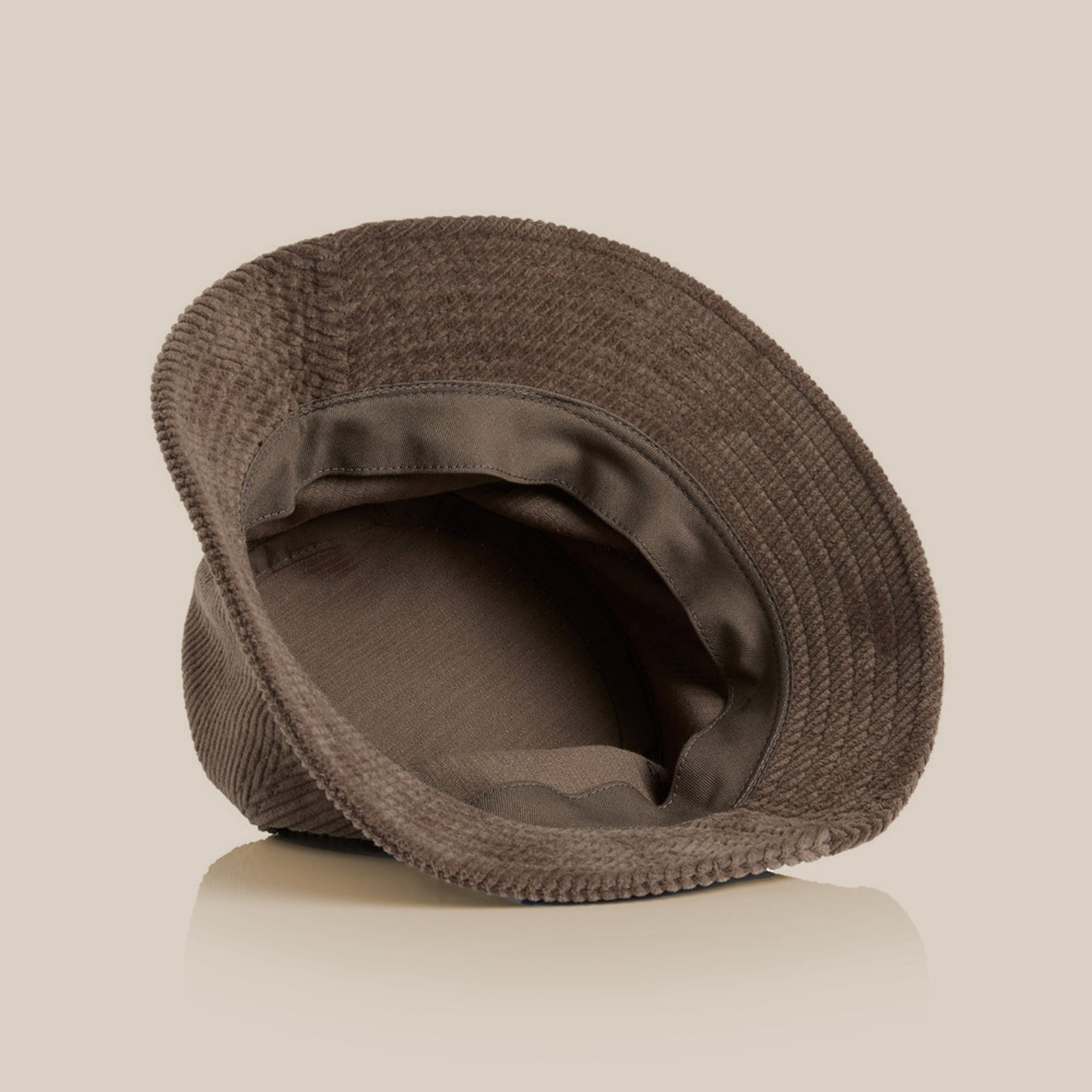 Inside view of the Field Drip brown corduroy bucket hat showing soft lining and stitching.