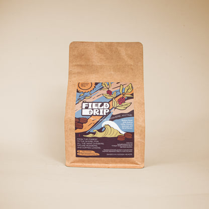 205g Field Drip coffee beans in a kraft paper bag on a beige background, studio product shot.