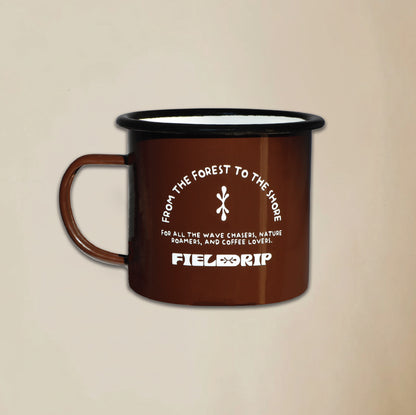 Field Drip enamel camping mug in walnut dark brown with white logo on a beige background.