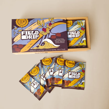 Field Drip open box of drip coffee sachets with packets fanned out on table.