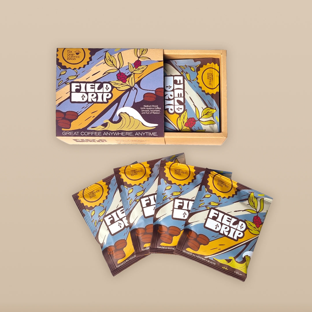 Field Drip open box with single-serve drip coffee sachets fanned out on a neutral background, flat-lay product packaging.