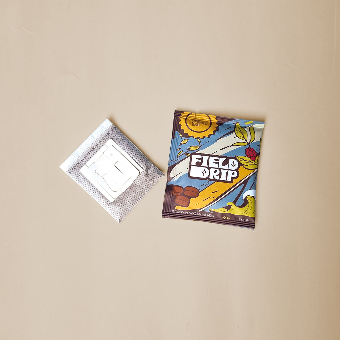 Field Drip single-serve drip coffee bag and filter sachet flat lay on beige background